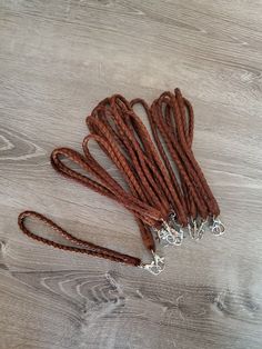 several pieces of red string sitting on top of a wooden table