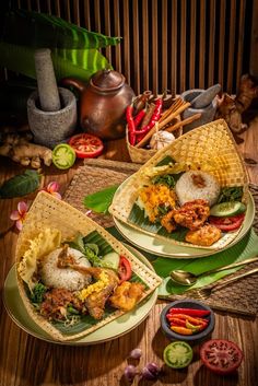 two plates filled with food on top of a wooden table