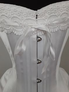 "Custom made Just for you! This striking beautiful pure white satin coutil corset is designed to create the ideal S-bend Edwardian silhouette. Steel boned throughout this lovely corset features front opening German steel busk, professional corset lacing. Handmade in the Canadian Rockies. Please allow 4 to 6 weeks until shipping. Rush orders available for a fee Required measurements Full bust Underbust Waist at smallest Hip at widest Length waist to midbust straight up Feedback on this item.. Tha Elegant Corset Belt With Boning And Sweetheart Neckline, Elegant White Lace Bodice, Satin Underbust Corset Dress With Corset Back, Satin Overbust Corset Dress With Corset Back, Underbust Corset Dress With Boning For Wedding, Elegant Lace Corset Belt With Corset Back, Formal Overbust Lace Corset, Wedding Overbust Corset With Boning, Wedding Corset With Boning And Fitted Bodice