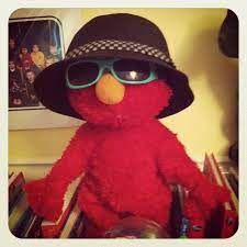 a red stuffed animal wearing sunglasses and a hat