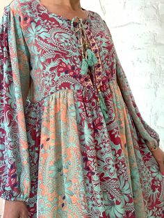 "This is beautiful light silky tunic dress with floral print in delicate blue and pink colours true boho chic style it is made loose and flared with high waist and long puff sleeve effortles to wear and easy fitting to all shapes perfect outfit for many occasions parties dinners birthday Christmas 😊 MEAESURE size M/L shoulders 18\" bust up to 40\" ( it is front tie srap, so can be easyli loosen up or tighten ) high waist 38\" length 45 \" MATERIAL *polisilk Thank You for looking" Spring Bohemian Chiffon Midi Dress, Patterned Long Sleeve Boho Dress With Floral Print, Flowy Long Sleeve Printed Maxi Dress, Green Boho Print Midi Dress, Flowy Patterned Maxi Dress For Fall, Long Floral Print Patterned Dress, Patterned Boho Dress With Long Sleeves, Bohemian Long Sleeve Chiffon Midi Dress, Pink Bohemian Chiffon Midi Dress