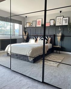 a bedroom with mirrored walls and a bed