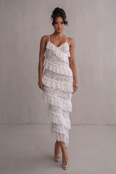 Designed for the JLUXLABEL Bridal Collection. Introducing the Ivory Feeling Of Forever Ruffle Dress, a masterpiece of elegance. Crafted from delicate lace with a nude underlining, this maxi dress exudes ethereal beauty. Its captivating ruffles cascade in an asymmetrical pattern, adding a touch of romance to your look. With a v-neckline and adjustable shoulder straps, it offers a flattering fit. Medium Stretch. Materials: 90% Nylon 10% Spandex (Contrast) 93% Nylon 7% Spandex(Lining) 94% Polyester Asymmetrical Pattern, One Shoulder Dress Long, Corsets And Bustiers, Ruffled Maxi Dress, Ethereal Beauty, Curve Dresses, Runway Collection, Cami Dress, Xl Dress