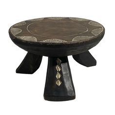 a wooden stool with an intricate design on the top and bottom, sitting in front of a white background