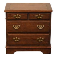 a wooden dresser with brass handles on it's top and bottom drawers, against a white background