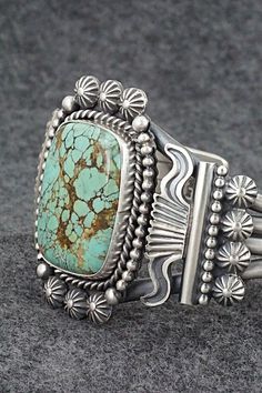 This stunning natural Number 8 turquoise and sterling silver bracelet was made by Navajo silversmith Michael Calladitto. The inside is signed Michael Calladitto and stamped Sterling.Size: 5 3/4" (will fit up to a 7" wrist)Gap: 1 1/4"Width: 1 7/8"Cuff Width: 5/8"Free shipping on all orders! We ship with USPS and always include tracking. All orders ship within a day of payment.Returns are accepted up to 30 days after you receive your order. Just send us a message. Our shop offers cash back or stor Southwestern Untreated Bracelet Jewelry, Southwestern Style Natural Bracelet, Handmade Turquoise Sterling Silver Western Bracelet, Handmade Turquoise Sterling Silver Southwestern Bracelet, Southwestern Silver Jewelry With Patina, Artisan Sterling Silver Turquoise Bracelet Collectible, Engraved Turquoise Southwestern Jewelry, Turquoise Sterling Silver Bracelet With Patina, Southwestern Sterling Silver Jewelry With Vintage Finish