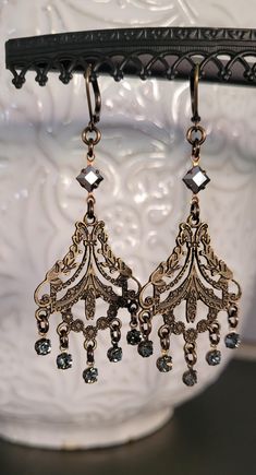 Be memorable in these eye-catching chandelier earrings designed with bronze etched metalwork and black diamond crystal drops and vintage mirrored Glass Crystals on top of the earrings.     Lightweight earrings.  These earrings are 3 "  inches long .  All jewelry is free of lead, free of nickel and eco-friendly.    All materials sourced from The USA , Italy, Austria, Spain, Portugal and The United Kingdom.  All my jewelry is made and designed with love for you to express yourself and your life with happiness , beauty and spirit. Victorian Era Jewelry, Vintage Earrings Victorian, Edwardian Earrings, Bronze Jewellery, 1920s Jewelry, Spain Portugal, Bronze Jewelry, Vintage Mirror, Lightweight Earrings