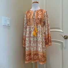 Nwt Made With Boho Dress Is A Pretty Floral Pattern Of Golds, Olive And Wine . Double Tie Front With Tassels. New With Tag . See Close Up Photos For Colors And Details Yellow V-neck Boho Dress For Spring, Yellow Boho Dress With Floral Print For Vacation, Casual Yellow Boho Print Dress, Summer Long Sleeve Orange Boho Dress, Orange Long Sleeve Boho Dress For Summer, Orange Long Sleeve Boho Dress With Print, Yellow Flowy Dress With Boho Print, Flowy Yellow Dress With Boho Print, Flowy Yellow Boho Print Dress