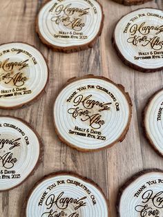 wood slices with wedding names on them are laid out on the table for guests to sign