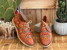 Let your shoes be the star of the show when you wear these beautiful Artisanal Mexican Shoes! These premium quality shoes are made from Mexican leather, feature beautiful multicolor traditional embroidered design and has laces for an adjustable fit. These are the highest quality in Artisanal leather shoes. They are completely made by hand, making them one of a kind! How to order your size: Example, If you wear a size 7.5 order a 7. If you are a size 7 order a 7. The sandal will mold to your feet Casual Embroidered Huarache Sandals For Festival, Traditional Leather Huaraches For Fiesta, Traditional Hand Tooled Huaraches With Round Toe, Traditional Hand Tooled Huaraches For Spring, Traditional Handmade Multicolor Huaraches, Embroidered Leather Huarache Sandals For Festival, Leather Embroidered Huarache Sandals For Festivals, Traditional Multicolor Slip-on Huaraches, Traditional Multicolor Leather Huaraches