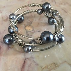 Gray Faux Pearl Memory Wire Bracelet Adjustable Gray Metal Jewelry, Elegant Gray Bracelet Jewelry, Elegant Gray Stretch Bracelet As Gift, Elegant Gray Bracelet, Elegant Gray Metal Jewelry, Silver Beaded Metal Pearl Bracelet, Silver Beaded Pearl Bangle Bracelet, Adjustable Silver Stretch Bracelet For Party, Silver Stretch Bangle Bracelet For Party