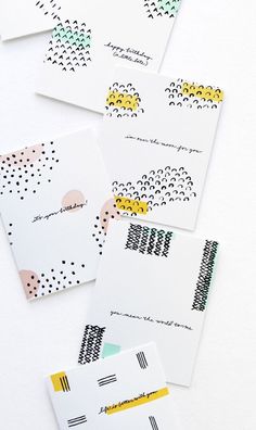 four cards with different designs on them, one is yellow and the other has black dots