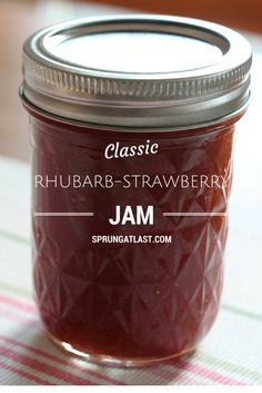 a jar filled with jam sitting on top of a table