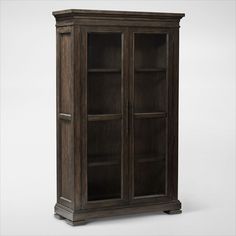 an old wooden bookcase with glass doors on the front and bottom shelves, against a white background