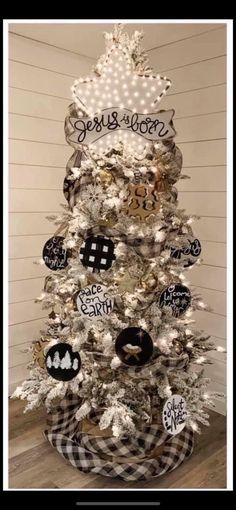 a white christmas tree decorated with black and white ornaments