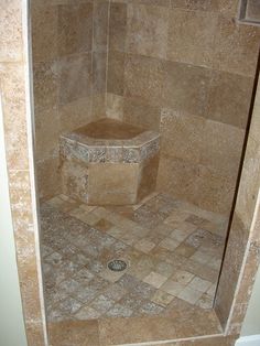 a walk in shower sitting inside of a bathroom