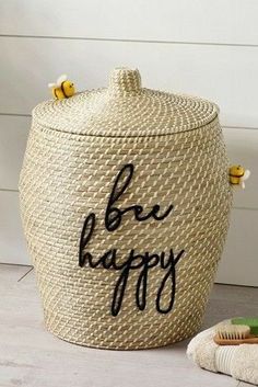 a large woven basket with the words be happy written on it next to a toothbrush