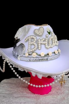 Beautiful white cowgirl hat with cursive Bride writen on the front with pearls and rhinestones. Silver detailing, with flowers, silver gems, butterflies, and rhinestones. Hanging around the brim is cute lace and pearls hanging, and a gold star hanging at the front. White Costume Hat For Western-themed Events, White Western-themed Costume Hat, White Western Hat With Rhinestones, Bride Cowgirl Hat, White Cowgirl Hat, Glam Cowgirl, Pearl Bride, Handmade Things, Cowgirl Hat