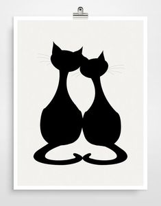 a couple of cats sitting next to each other on top of a white poster frame