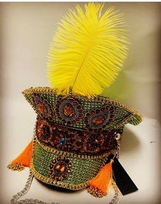 This is a stunning green captain hat. It is enriched with lots of detail , gems , tassels , vibrant yellow feather to name a few. This is a hand crafted hat in a size 59cm which fits most heads.  Please note any traces of glue is not a defect but characteristics of a hand created item. No two hats are created the same so this is an individual item. Thank you for looking Mardi Gras Festival Costume Hat With Round Crown, High Crown Costume Hats For Carnival, High Crown Costume Hat For Carnival Festival, Carnival Festival High Crown Top Hat, Bohemian Crown Headpiece For Carnival, Fantasy Costume Hat With High Crown For Festivals, Bohemian Crown Costume Hat For Carnival, Bohemian Mardi Gras Party Costume Headpiece, Handmade Tall Crown Costume Hat