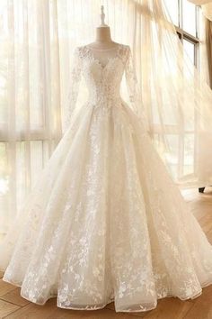 a wedding dress on display in front of a window