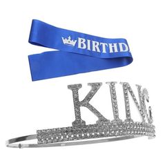 two tiaras with the words'birth'and'king'in silver on a blue ribbon