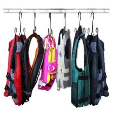 several coats hanging from hooks on a rack