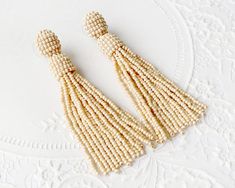 Oscar de la renta earrings Beaded tassel earrings Long beige | Etsy Elegant Beaded Dangle Earrings With Tassels, Elegant Tassel Earrings With Round Dangling Beads, Elegant Beaded Fringe Earrings, Elegant Beaded Fringe Chandelier Earrings, Elegant White Beaded Tassel Earrings, Elegant Beige Beaded Earrings For Gift, Elegant Beaded Earrings With Tassels For Gift, Elegant Gift Beaded Earrings With Tassels, Elegant Beige Beaded Earrings