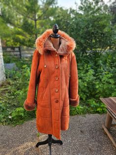 "Brand is unknown. This coat was brought from Kyrgyzstan country a long time ago, so it's vintage. Can fit Medium or Small. It says XL on the lining tag, but I don't think it will fit XL. Introducing a cozy and stylish coat, perfect for those chilly days in the northern states. This long coat features a luxuriously warm fur hoodie and a snug lining that provides exceptional insulation. Its unique and mysterious outer material adds a touch of intrigue, while the excellent condition guarantees bot Vintage Hooded Jacket For Cold Fall Weather, Luxury Hooded Parka For Fall, Luxury Hooded Fall Parka, Vintage Hooded Parka For Fall, Vintage Winter Parka For Cold Weather, Vintage Parka For Winter, Vintage Hooded Fur Coat For Fall, Vintage Parka With Double-lined Hood For Fall, Vintage Hooded Outerwear For Fall