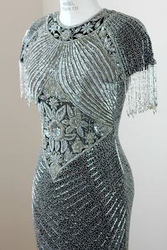 "Timeless Heavily beaded Gown. This gown is absolutely Stunning! This gown is covered with beads crystals, and pearls. You will look like an icon in this piece. It is in excellent condition Measuring: 55\" long Bust: 34\" Waist: 26\" Hip: 34\" Pet Free/smoke free Outstanding in every way Enjoy!" Glamorous Beaded Evening Dress For Prom, Glamorous Fitted Beaded Gown, Beaded Floor-length Gown For Gala, Beaded Fitted Dress For Receptions, Glamorous Beaded Gala Gown, Floor-length Beaded Fringe Evening Dress, Silver Beaded Gala Dress, Silver Beaded Evening Dress For Party, Glamorous Evening Gown With Beads