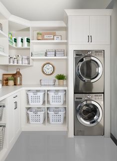 a washer and dryer in a white laundry room with open shelving on the wall