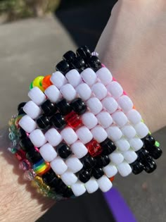 a close up of a person's hand wearing a bracelet made out of plastic beads