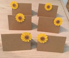 six yellow flowers are placed on top of each other in small brown envelopes with cards attached to them