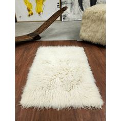 a white rug is on the floor next to a chair