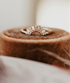 a diamond ring sitting on top of a wooden box