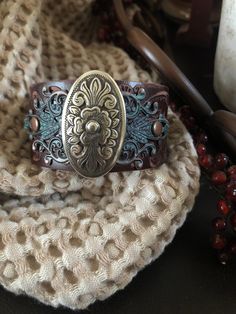 "Country leather bracelet cuff, western jewelry Embossed distressed genuine brown leather 1 1/2\" strap has been adorned with an oval southwestern silver concho which sets on a detailed antiqued copper filigree which has been given a rich patina. It is attached to the leather with two antiqued copper rivets. One antiqued copper snap has been placed to fit up to a 7 1/4\" wrist. I can add another snap if you would like a smaller or larger size but you need to convo me before purchasing The last p Bohemian Hand Tooled Jewelry For Rodeo, Western Concho Bracelets For Festival, Western Style Concho Bracelets For Festivals, Vintage Leather Bracelet With Concho, Brown Bohemian Leather Bracelet With Concho, Vintage Hand-tooled Leather Cuff Bracelet, Bohemian Hand-tooled Cuff Bracelet, Southwestern Leather Bracelet With Concho For Gifts, Southwestern Leather Bracelet With Concho As Gift