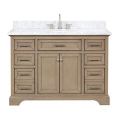 a bathroom vanity with marble top and drawers