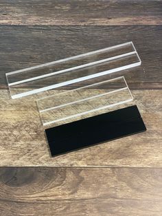 two clear acrylic stands on top of a wooden floor