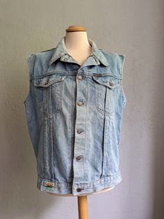 Vintage oversized denim vest Light blue denim vest Button down vest 90s aesthetic clothes Good vintage condition. See the photo. Composition - Cotton Brand - Paradiso. Made in Belgium Size - L Measurements: Length - 63 cm (24.8 in) From pit to pit - 54 cm (21.3 in) All measurements were taken on a horizontal surface. Cheap Retro Blue Denim Vest, Sleeveless Denim Vest With Pockets For Streetwear, Blue Sleeveless Cotton Denim Jacket, Blue Washed Sleeveless Vest, Casual Sleeveless Denim Jacket For Streetwear, Light Wash Cotton Denim Vest For Streetwear, Light Wash Denim Vest With Pockets For Streetwear, Light Wash Sleeveless Denim Vest With Pockets, Retro Blue Cotton Denim Vest