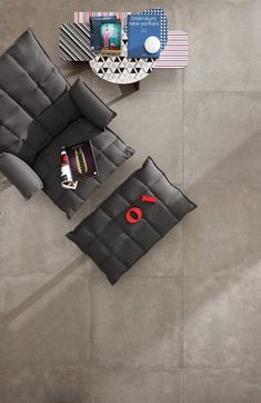 an overhead view of a living room with grey tiles