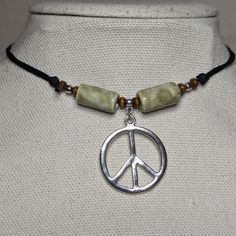 Sage Green Silver Peace Sign Charm Ceramic Wooden Beaded Boho Hippie Adjustable Black Rope Cord Choker Necklace Comes On An Adjustable Waxed Black Cord Necklace. Necklace Is Adjustable From Approximately 13" To 22". Bohemian Jewelry Necklaces, Nickel-free Adjustable Casual Necklace, Casual Adjustable Nickel Free Necklace, Adjustable Nickel-free Beaded Necklace, Silver Casual Beaded Necklace Gift, Silver Casual Beaded Necklace For Gift, Casual Silver Beaded Necklace For Gifting, Casual Silver Beaded Necklace As Gift, Woodstock Theme