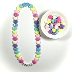 "You have just found the perfect gift for birthdays or Easter! This cute pastel, retro HEART necklace can come personalized or with hearts only. This 16\" stretchy necklace fits right over your head so it's easy to put on- no clasps needed. The matching bracelet is listed here: https://www.etsy.com/listing/909362079/kids-heart-bracelet-party-favor-girls?ref=shop_home_active_5&frs=1 Please check all selections and spelling prior to check out. Our custom jewelry is made to order so all sales a Bracelet Party, Retro Heart, Girls Necklace, Jewelry For Girls, Necklace Cute, Matching Bracelet, Name Jewelry, Birthday Gifts For Kids, Girls Necklaces