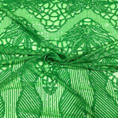 green lace fabric with an intricate design