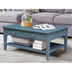 a blue coffee table sitting on top of a rug