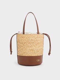 Beige Bucket Bag With Intrecciato Weave, Luxury Natural Leather Bucket Bag, Luxury Woven Leather Straw Bucket Bag, Luxury Straw Bucket Bag With Woven Leather, Beige Bucket Bag With Intrecciato Weave For Vacation, Luxury Leather Basket Bucket Bag, Luxury Rectangular Straw Bucket Bag, Luxury Leather Bucket Bag For Spring, Luxury Spring Leather Bucket Bag