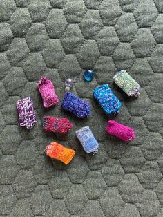 there are many small knitted objects on the floor