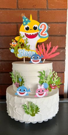 a three tiered cake decorated with cartoon characters