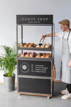 a man standing in front of a donut shop