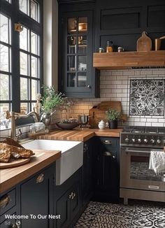 a kitchen with black cabinets and white tiles on the floor, along with wooden counter tops