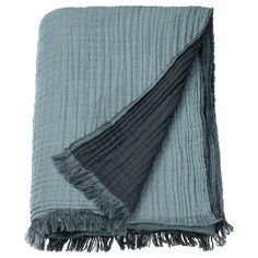 a blanket with fringes on the bottom and one folded up in grey, black and white